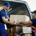delivery-men-loading-carboard-boxes-van-while-getting-ready-shipment-2-1536x1024
