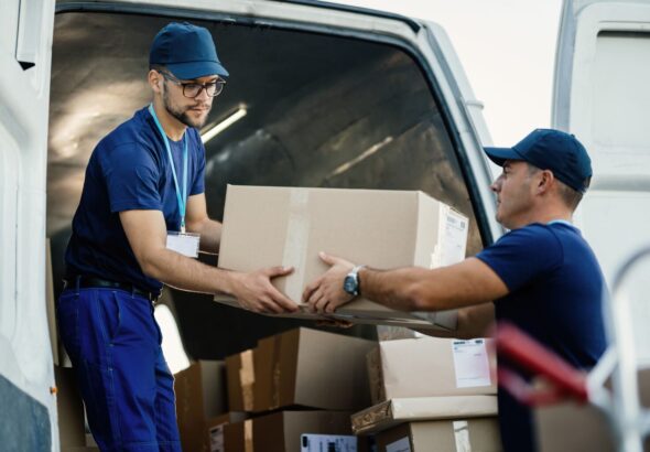 delivery-men-loading-carboard-boxes-van-while-getting-ready-shipment-2-1536x1024